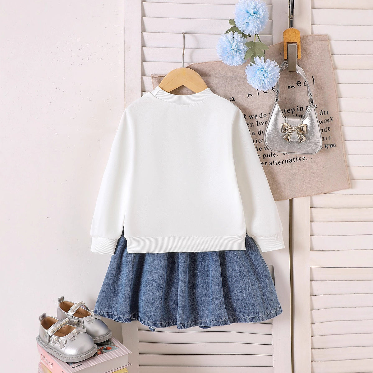 Two piece set of long sleeved sweatshirt with pleated denim skirt