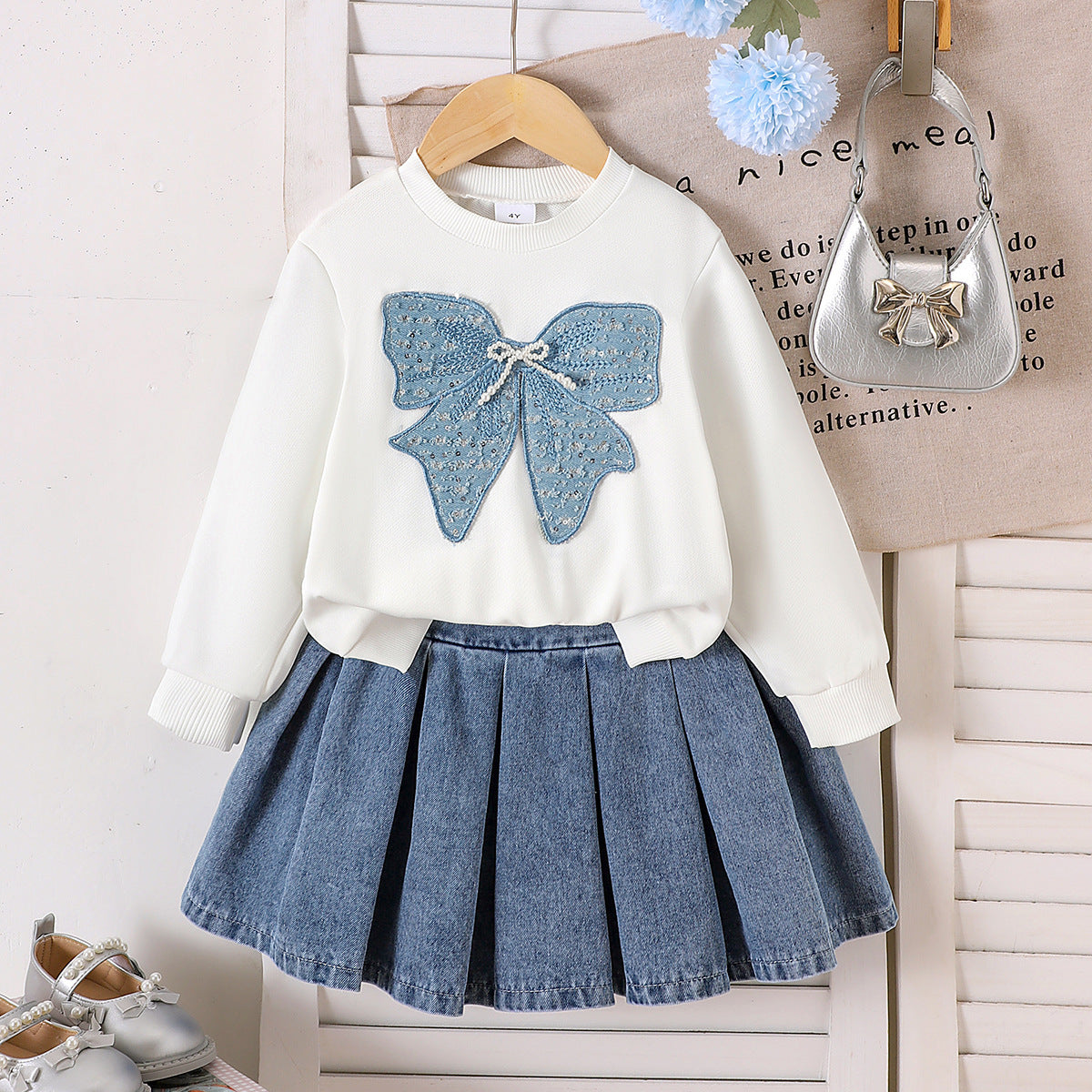 Two piece set of long sleeved sweatshirt with pleated denim skirt