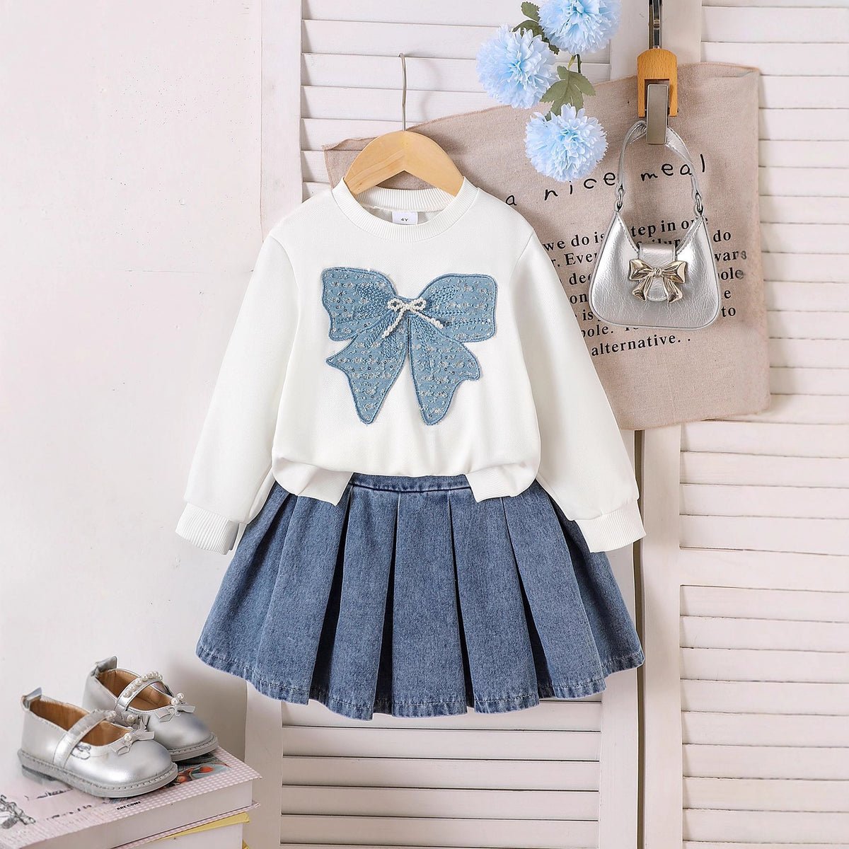 Two piece set of long sleeved sweatshirt with pleated denim skirt
